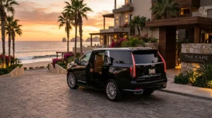 Luxury SUV parked at a beautiful Los Cabos resort, symbolizing premium private transfer.